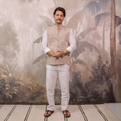 Full-length view of Skin Tone Cotton Bhagalpur Nehru Jacket for Men styled with a white kurta and pajama.