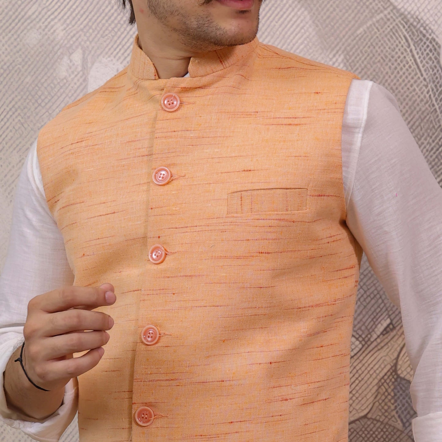 Close-up of Orange Handloom Cotton Bhagalpur Nehru Jacket for Men showcasing the handloom texture and button detailing.