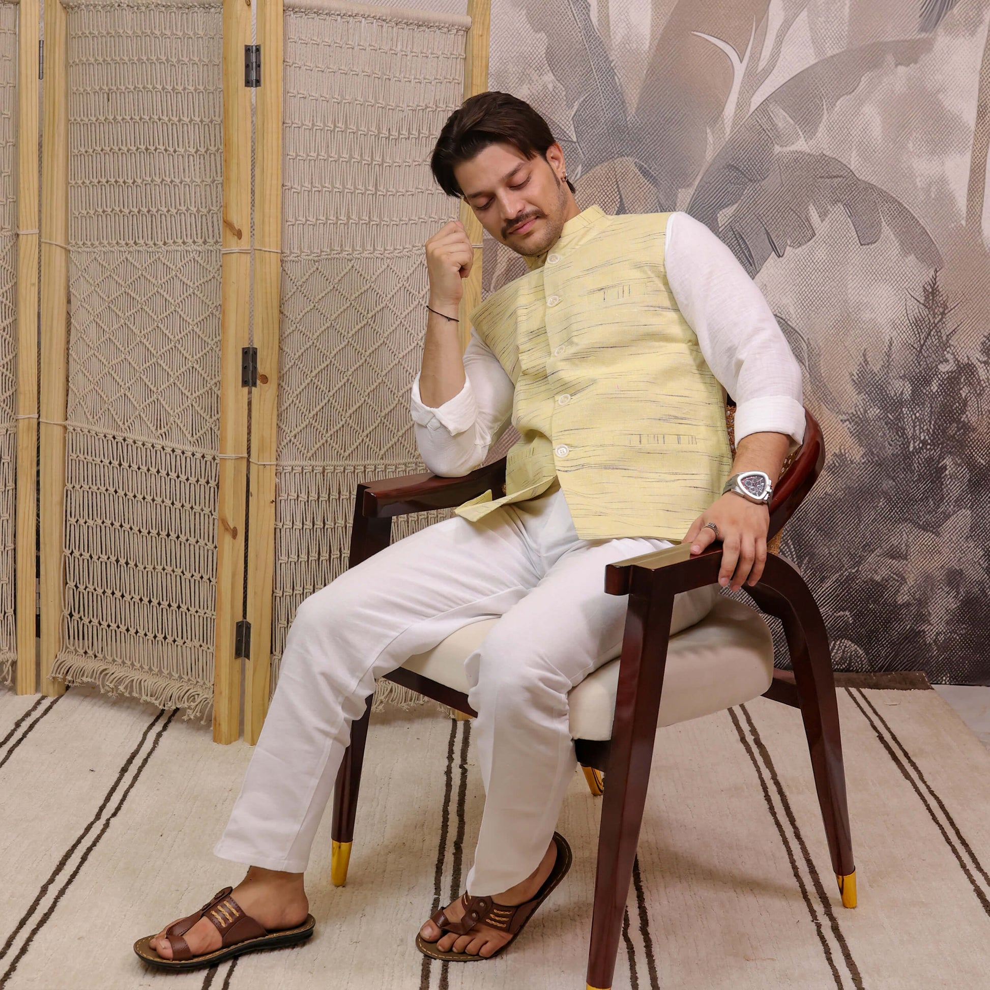 Yellow Handloom Cotton Bhagalpur Modi Jacket for Men | Kargham styled with a white kurta while seated for a festive ethnic look.