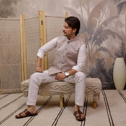 Grey Handloom Cotton Bhagalpur Modi Jacket for Men | Kargham styled with a white kurta in a seated pose.