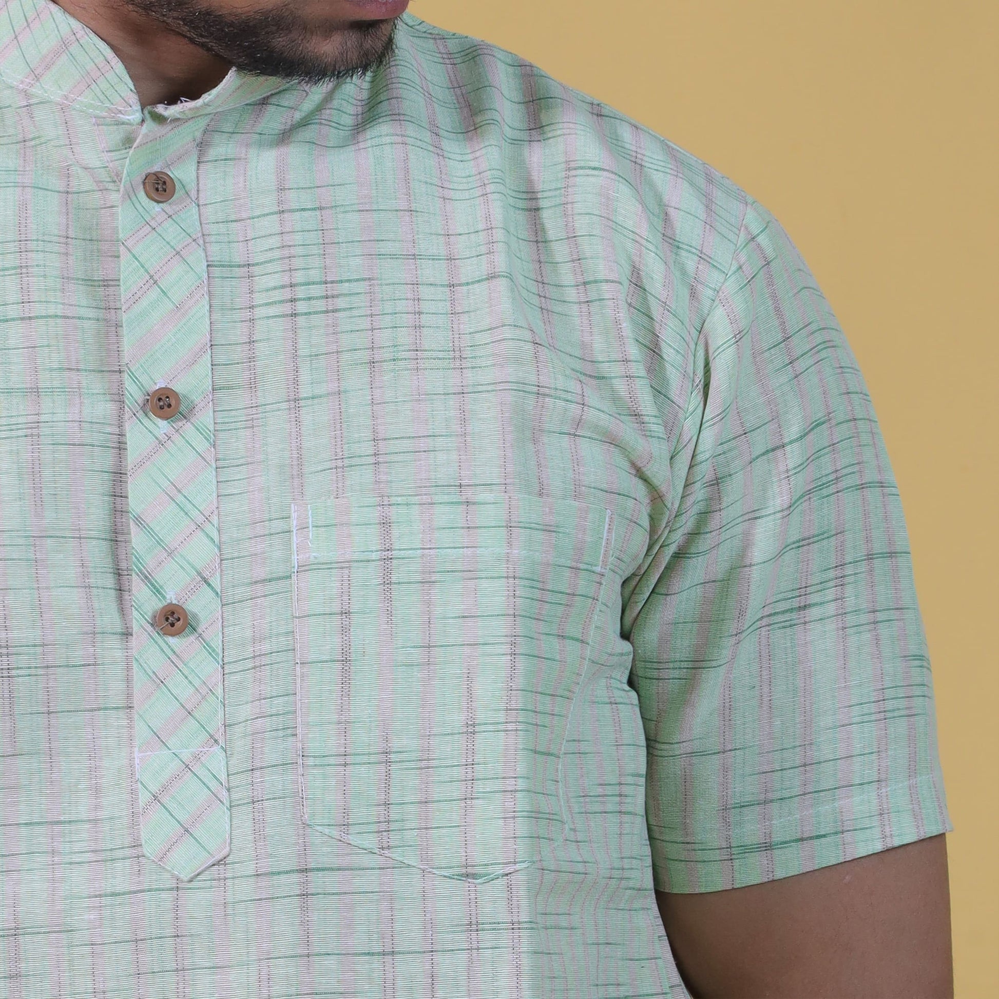 green khadi kurta fabric golden stripe detail close-up
