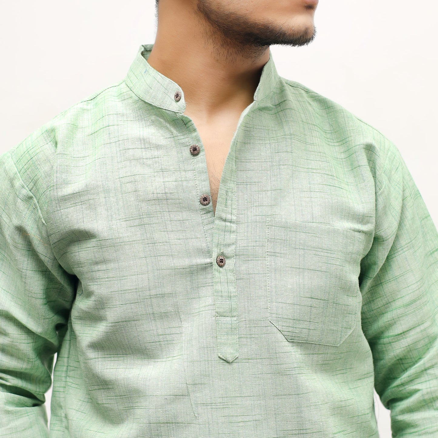 Close-up of green cotton khadi short kurta textured fabric and mandarin collar