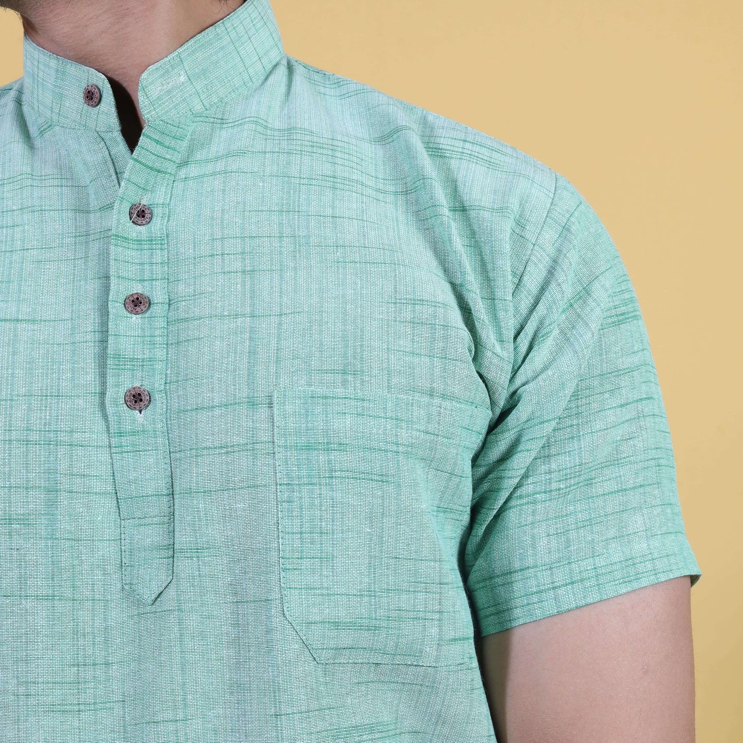 Close-up of green khadi kurta with jharna texture and buttons