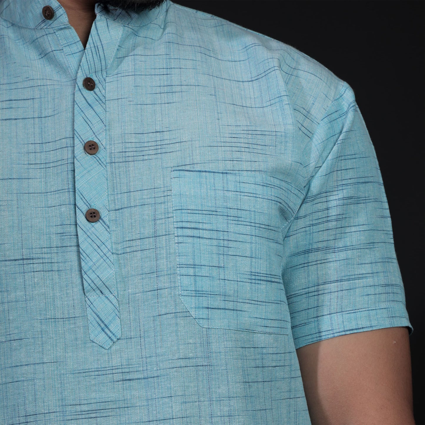 Close-up of sky blue khadi kurta with textured jharna weave and buttons