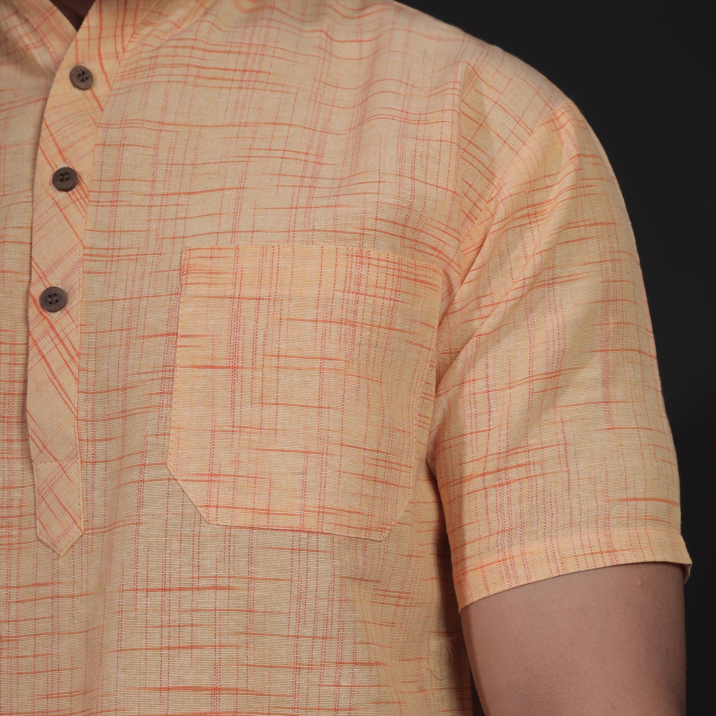 Close-up of yellow khadi kurta with jharna texture and chest pocket