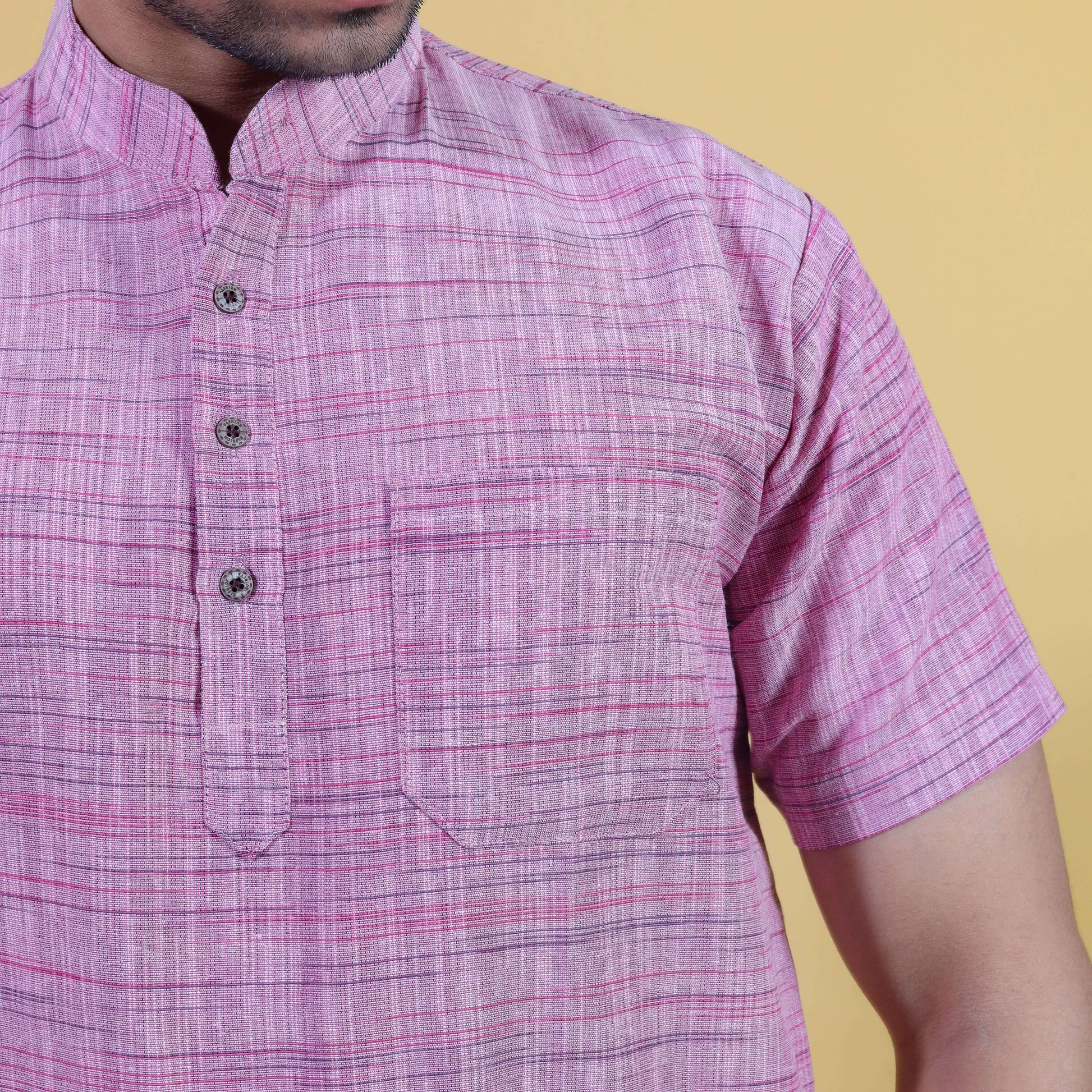 Close-up pink khadi kurta fabric with textured Jharna weave