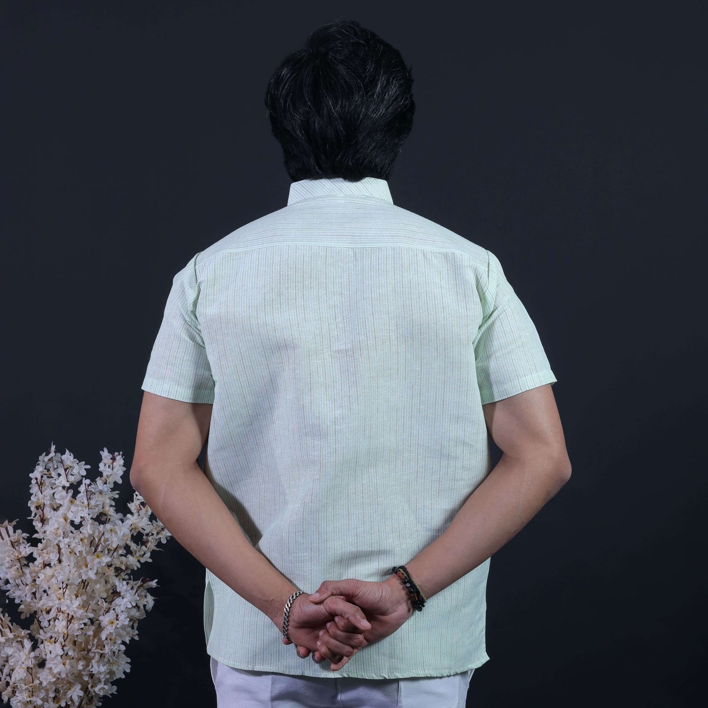 Back view of green loomstripe handwoven-inspired short kurta for men
