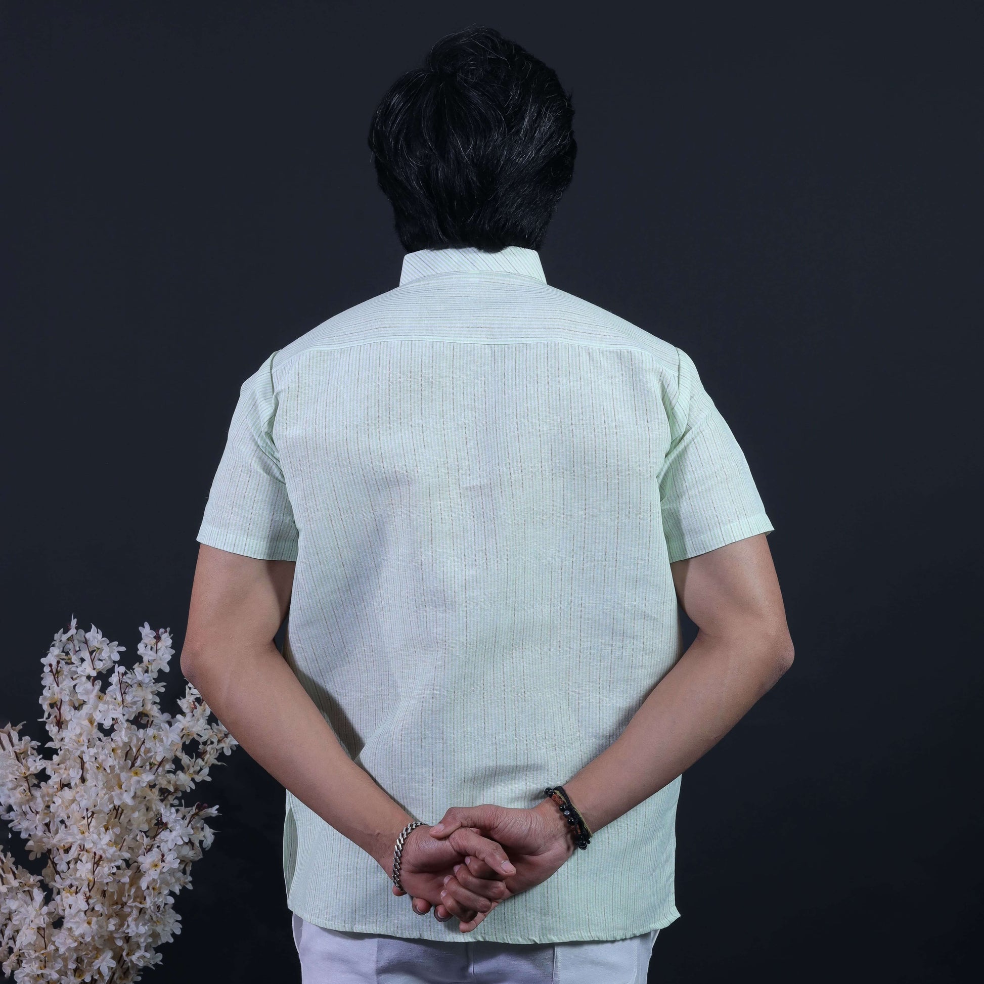 Back view of green loomstripe handwoven-inspired short kurta for men