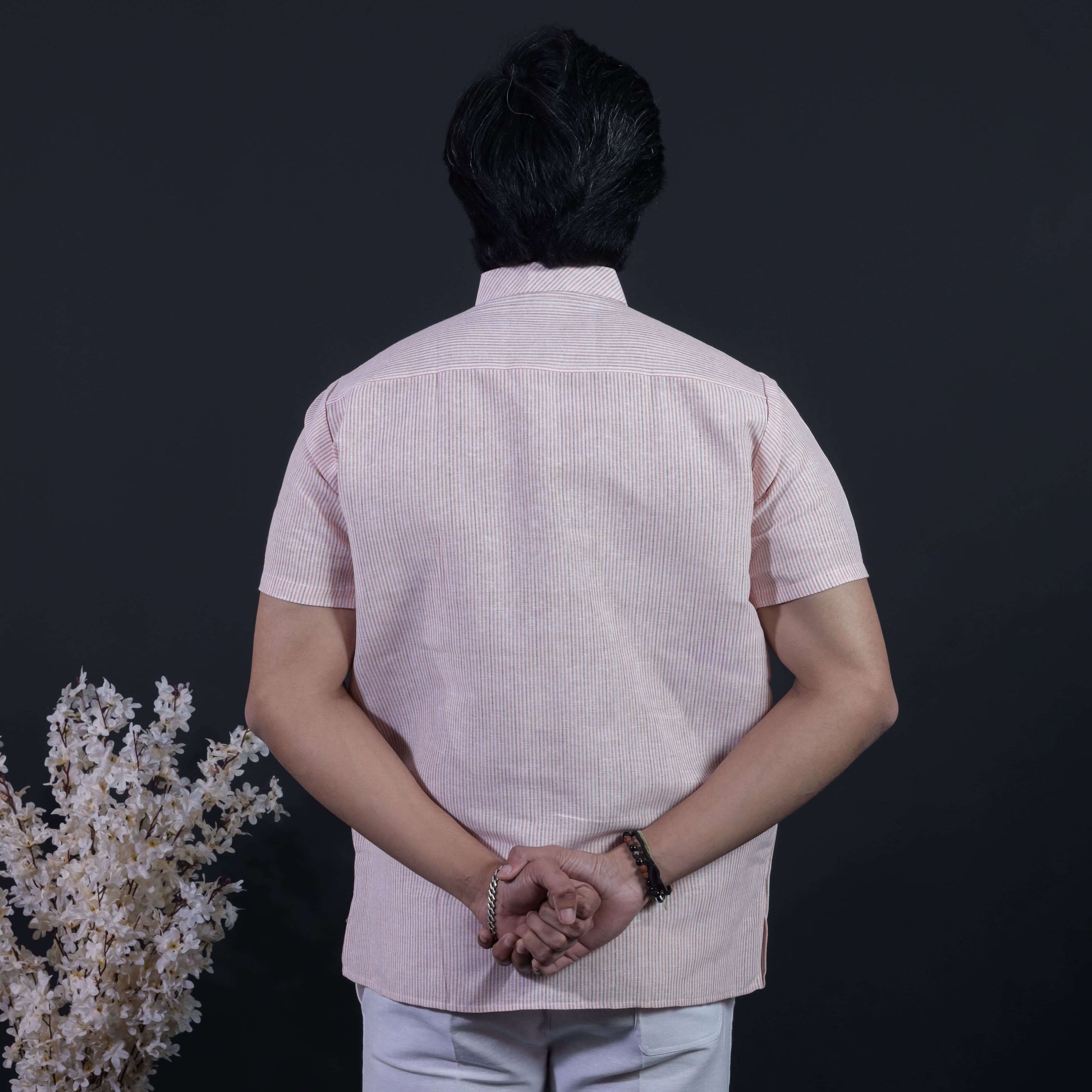 Back side view of orange loomstripe kurta pant combo set