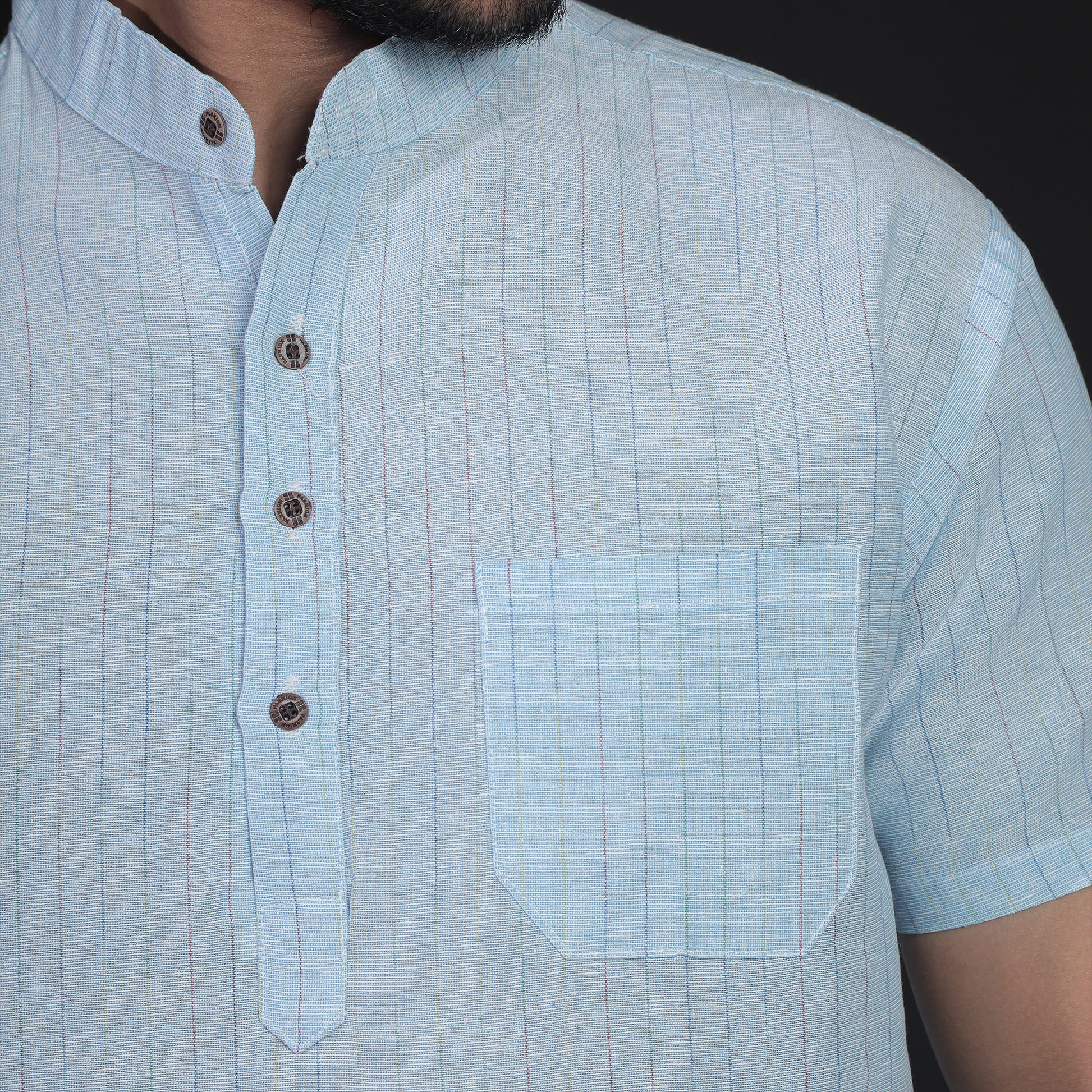 Close-up of blue softline striped khadi cotton kurta collar and pocket detail