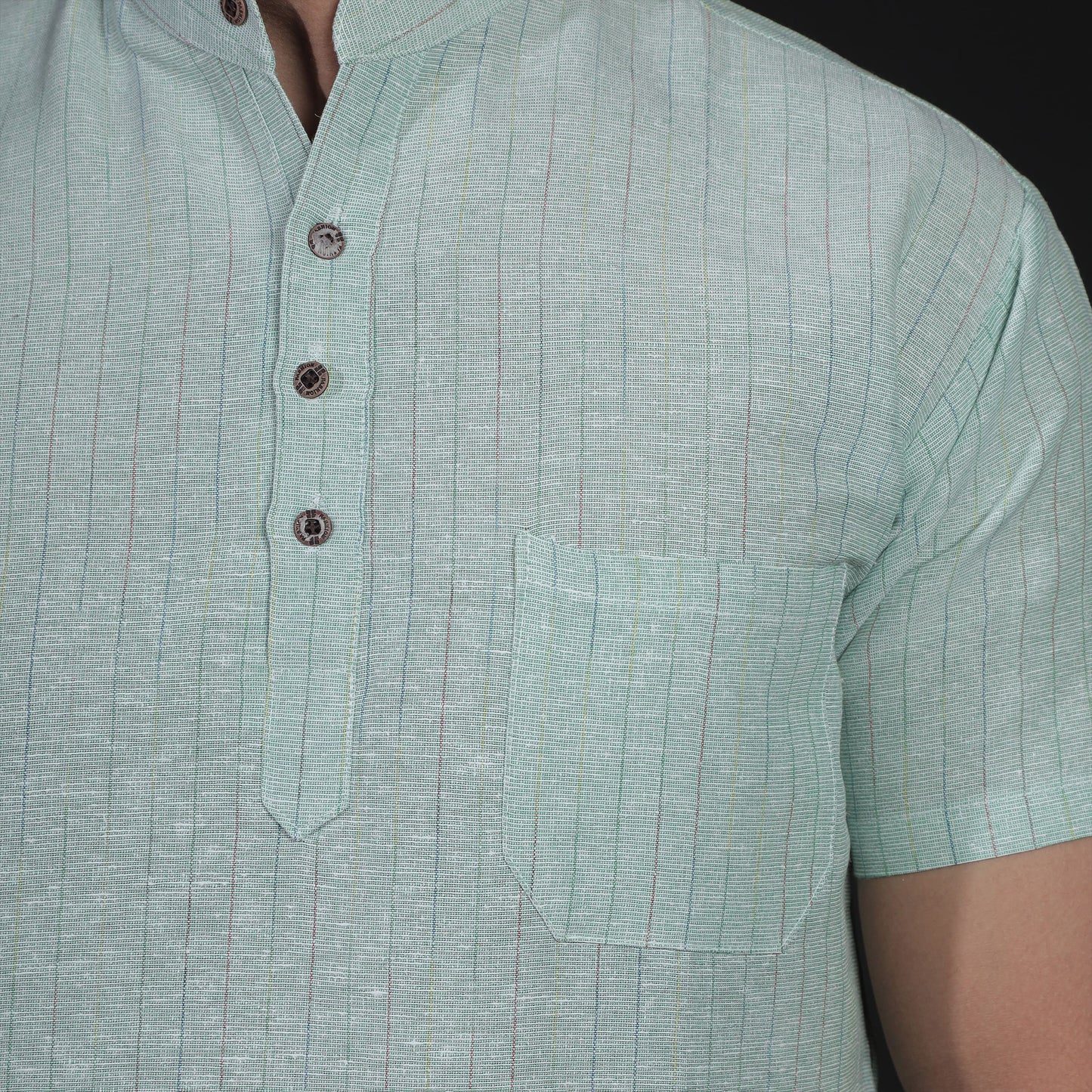 Close-up of green striped khadi-inspired short kurta texture for men