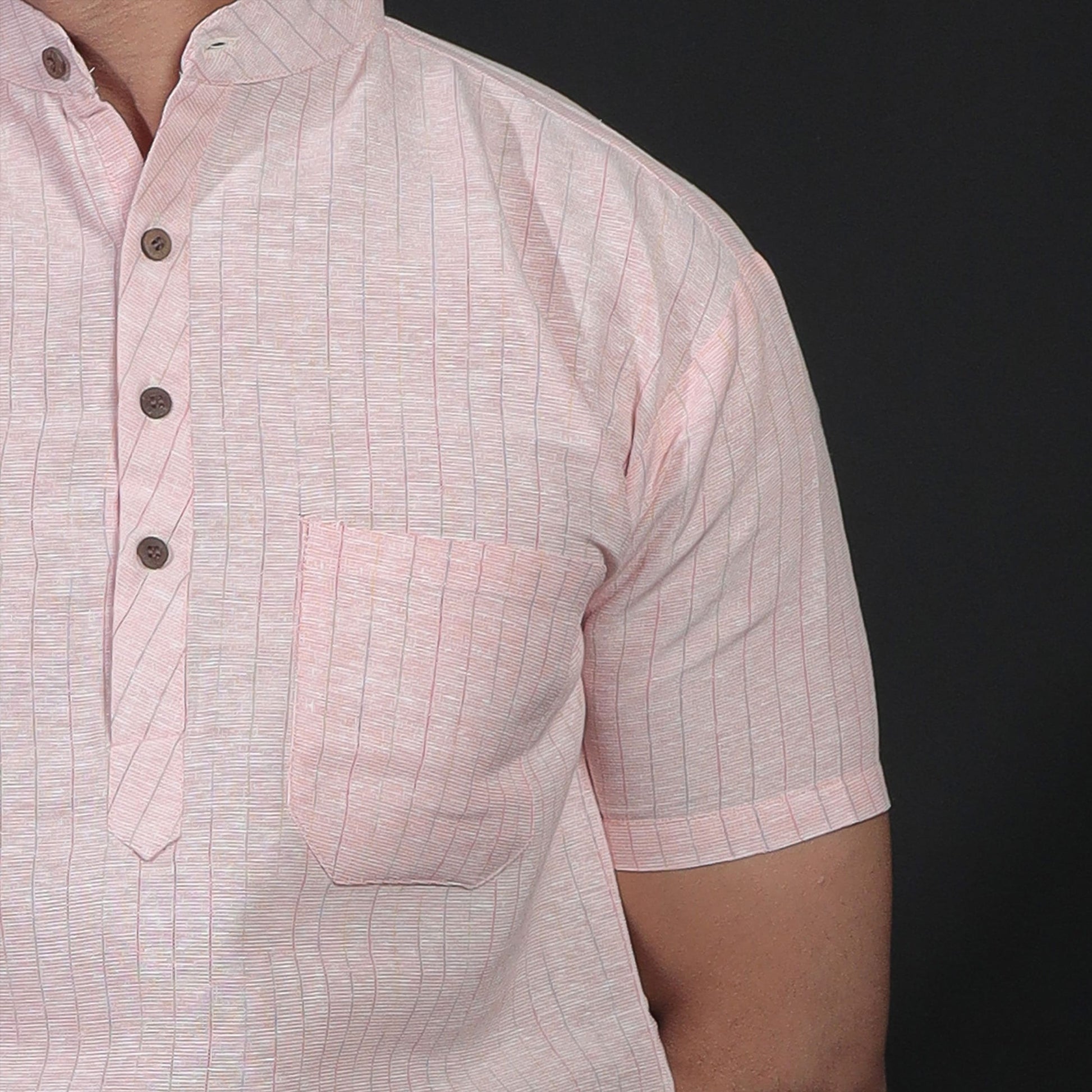 Close-up view of orange striped handwoven kurta pocket and collar detail