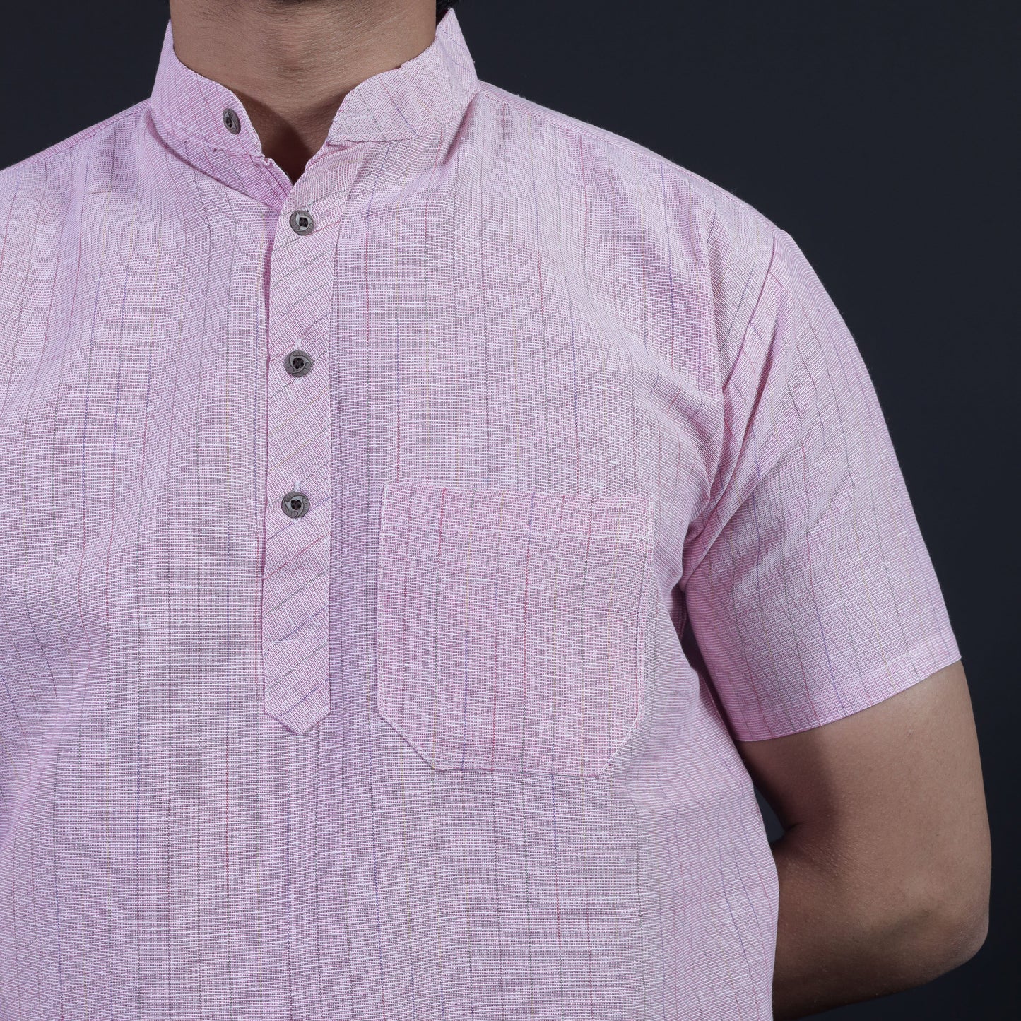 Close-up of pink striped khadi-inspired kurta fabric and pocket detailing