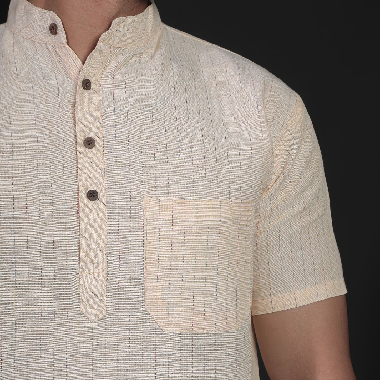Close-up of yellow striped handwoven kurta collar and pocket detail