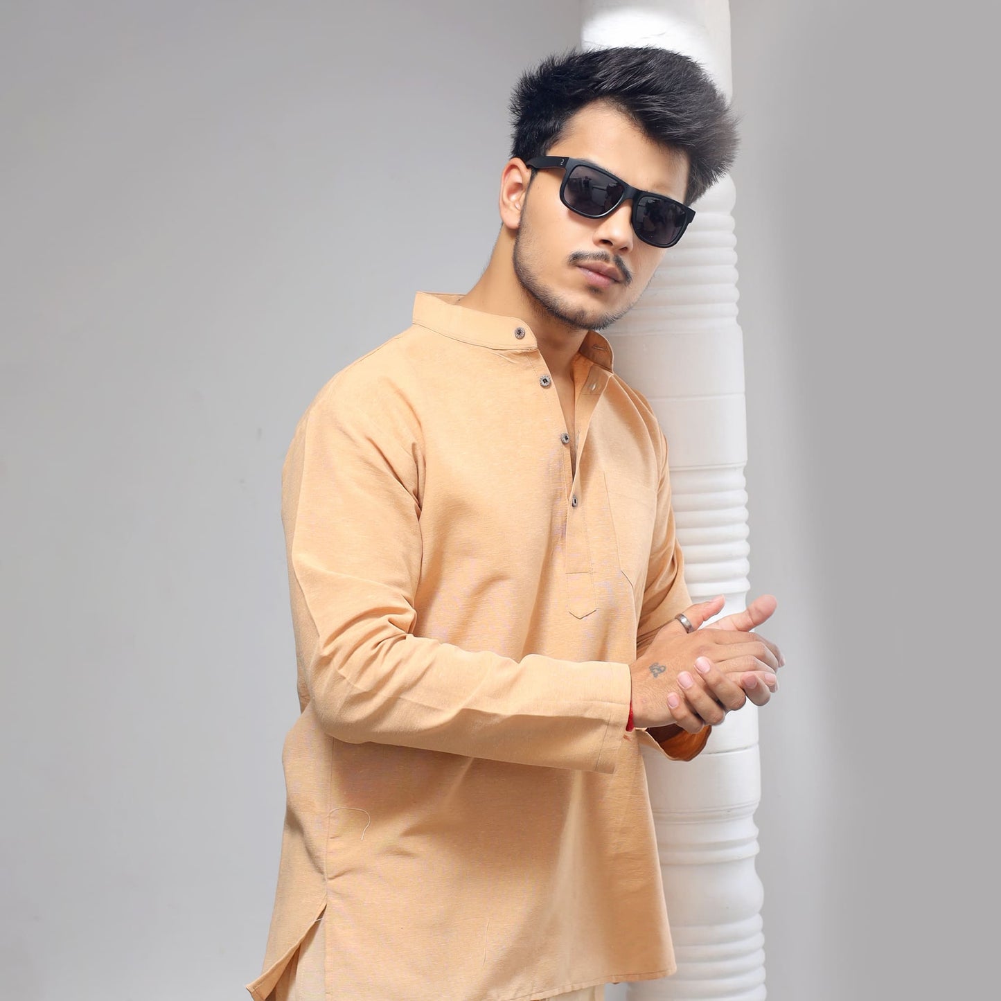 Beige khadi short kurta casual ethnic look standing near pillar