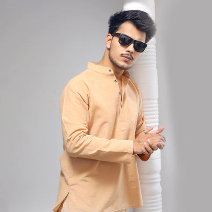 Beige khadi short kurta casual ethnic look standing near pillar