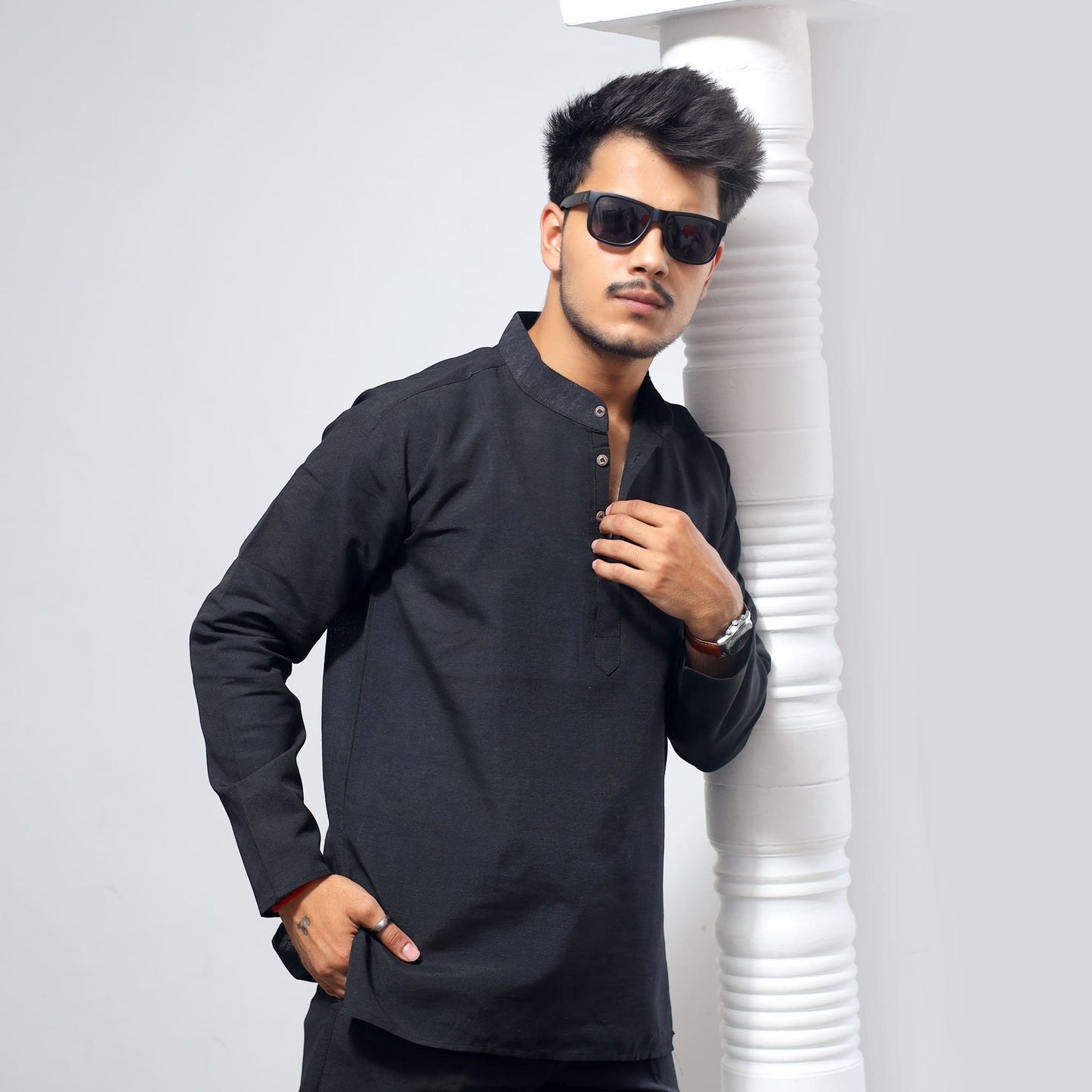 Black khadi cotton kurta full sleeves leaning pose with modern ethnic styling
