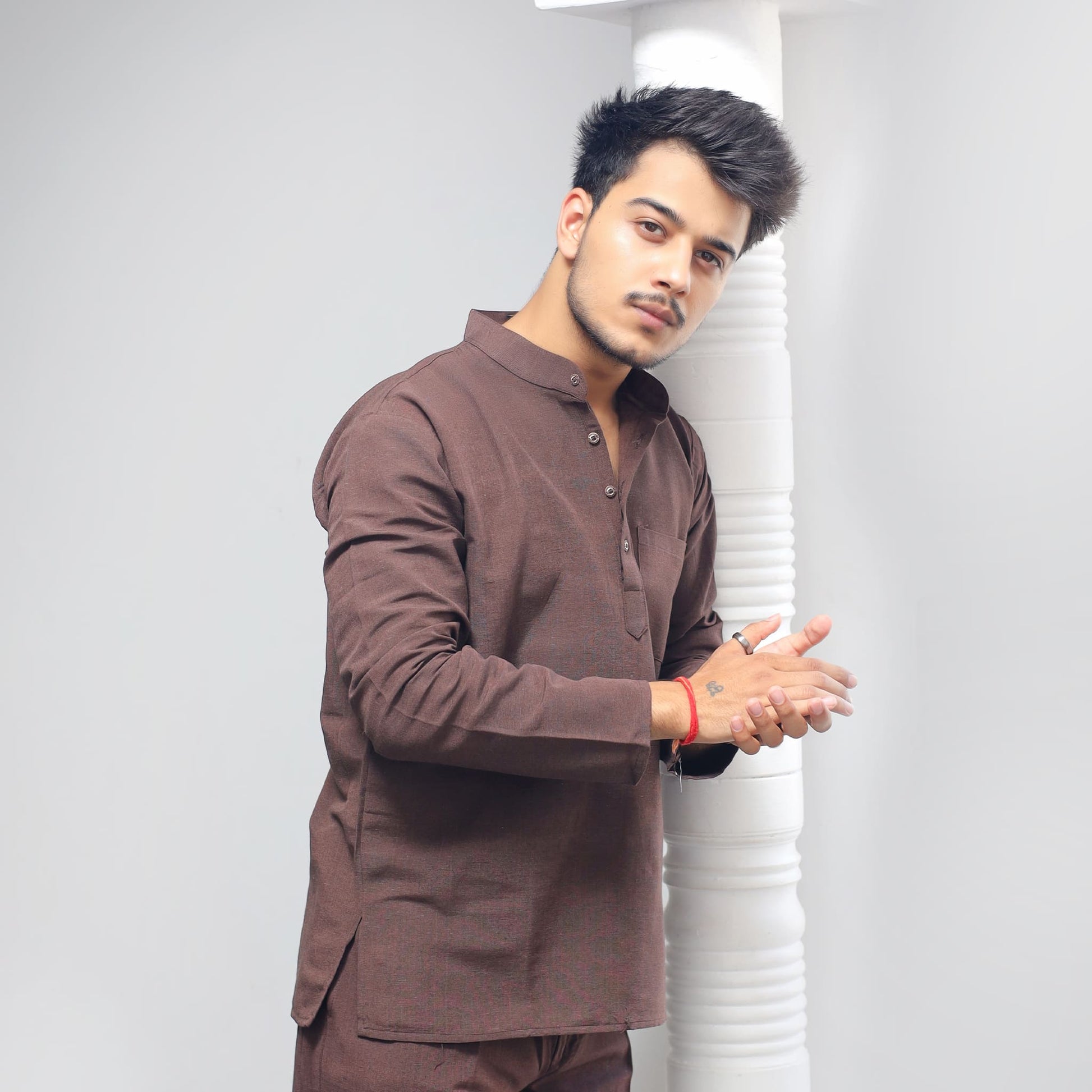Brown Solid Full Sleeves Khadi Cotton Short Kurta side view near pillar styling pose