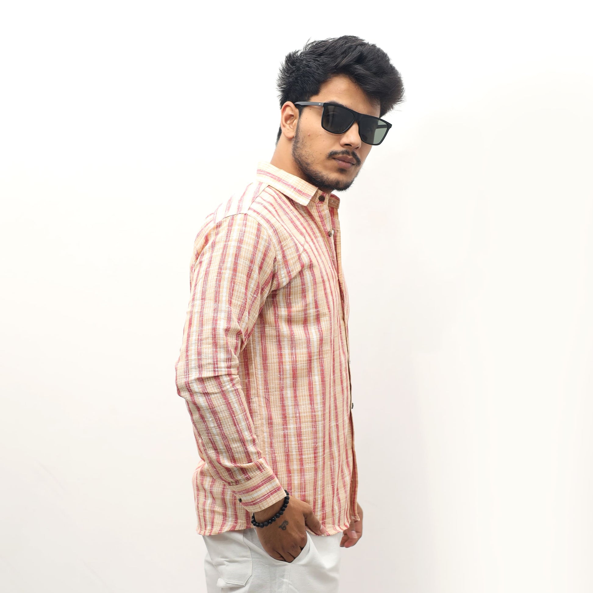 Orange striped khadi shirt men styling with sunglasses side pose