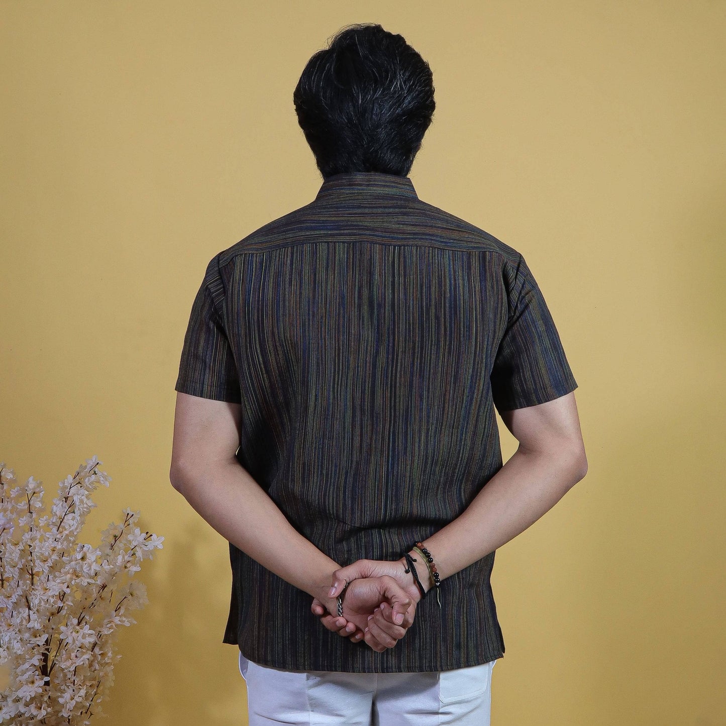 Back view of black striped khadi short kurta showcasing vertical thread line texture