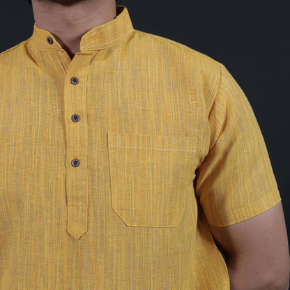 Close-up of yellow khadi kurta with fine thread lines texture