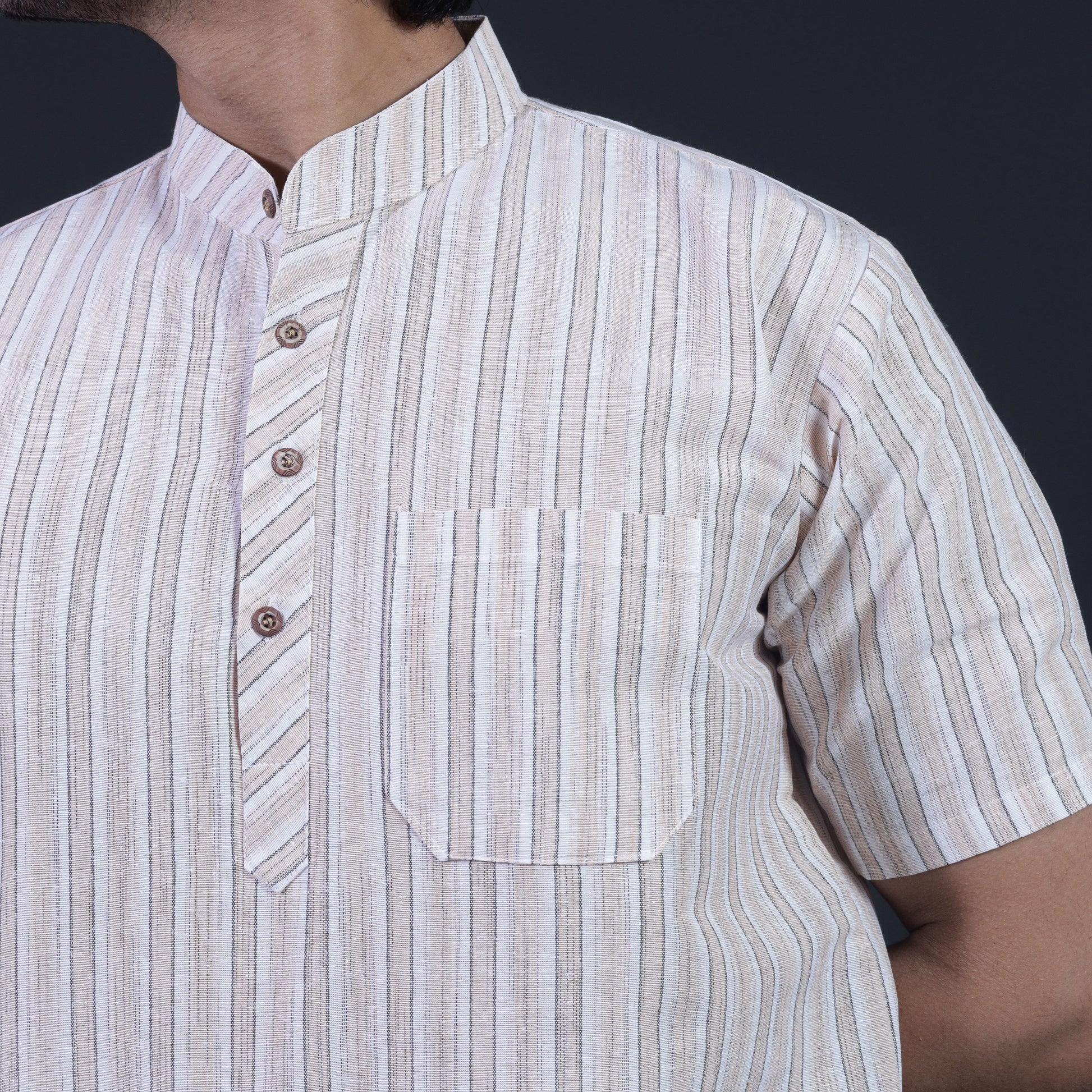 Close-up of beige white striped short kurta pocket and collar