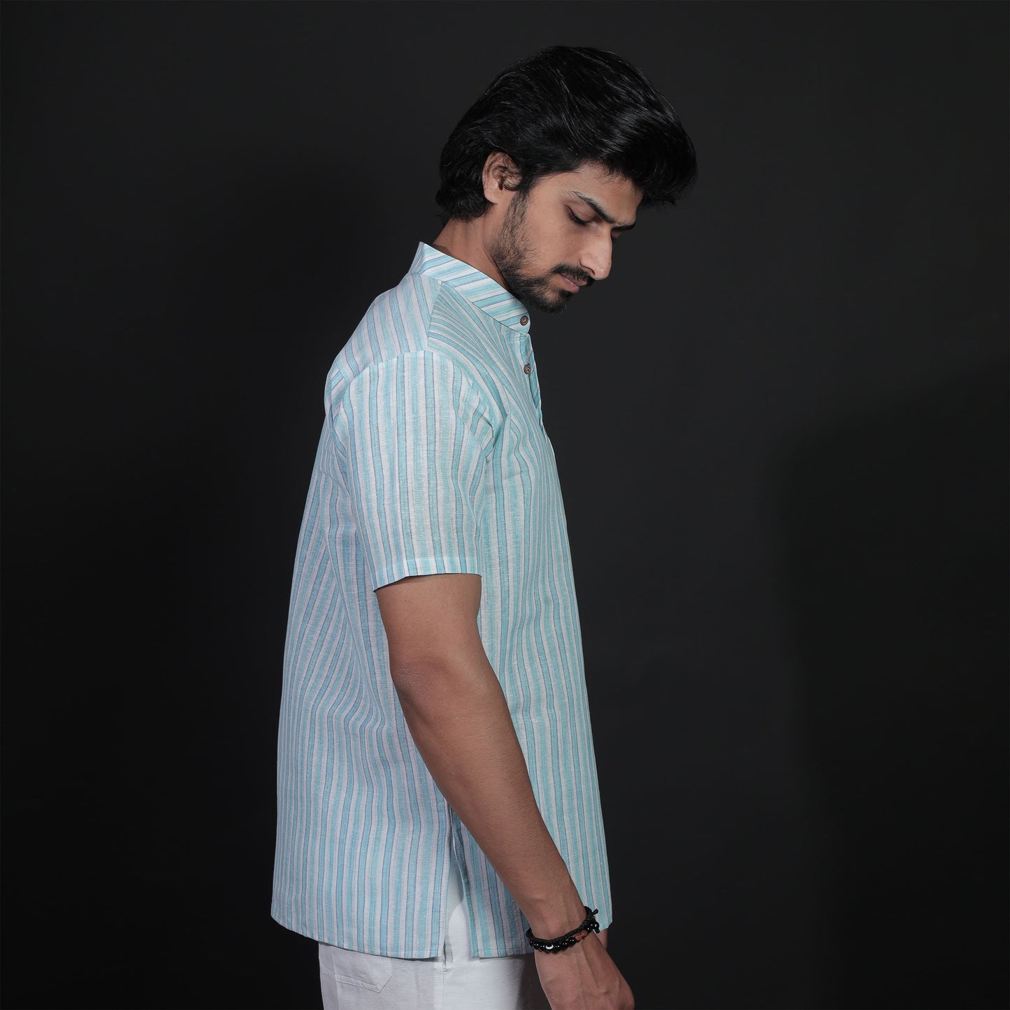 Side profile showing fit of blue striped half sleeves kurta
