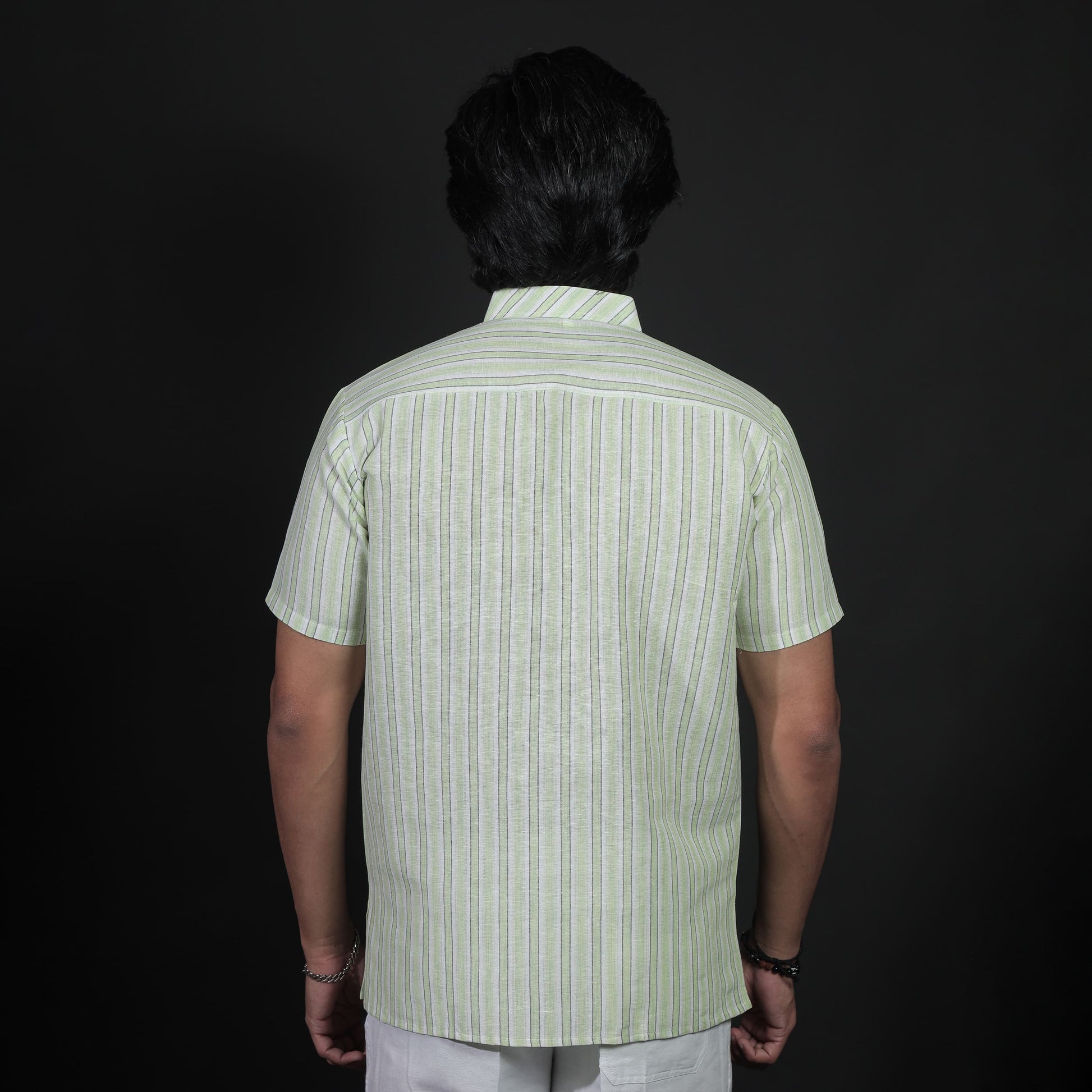 Back view of green striped khadi short kurta with vertical pattern