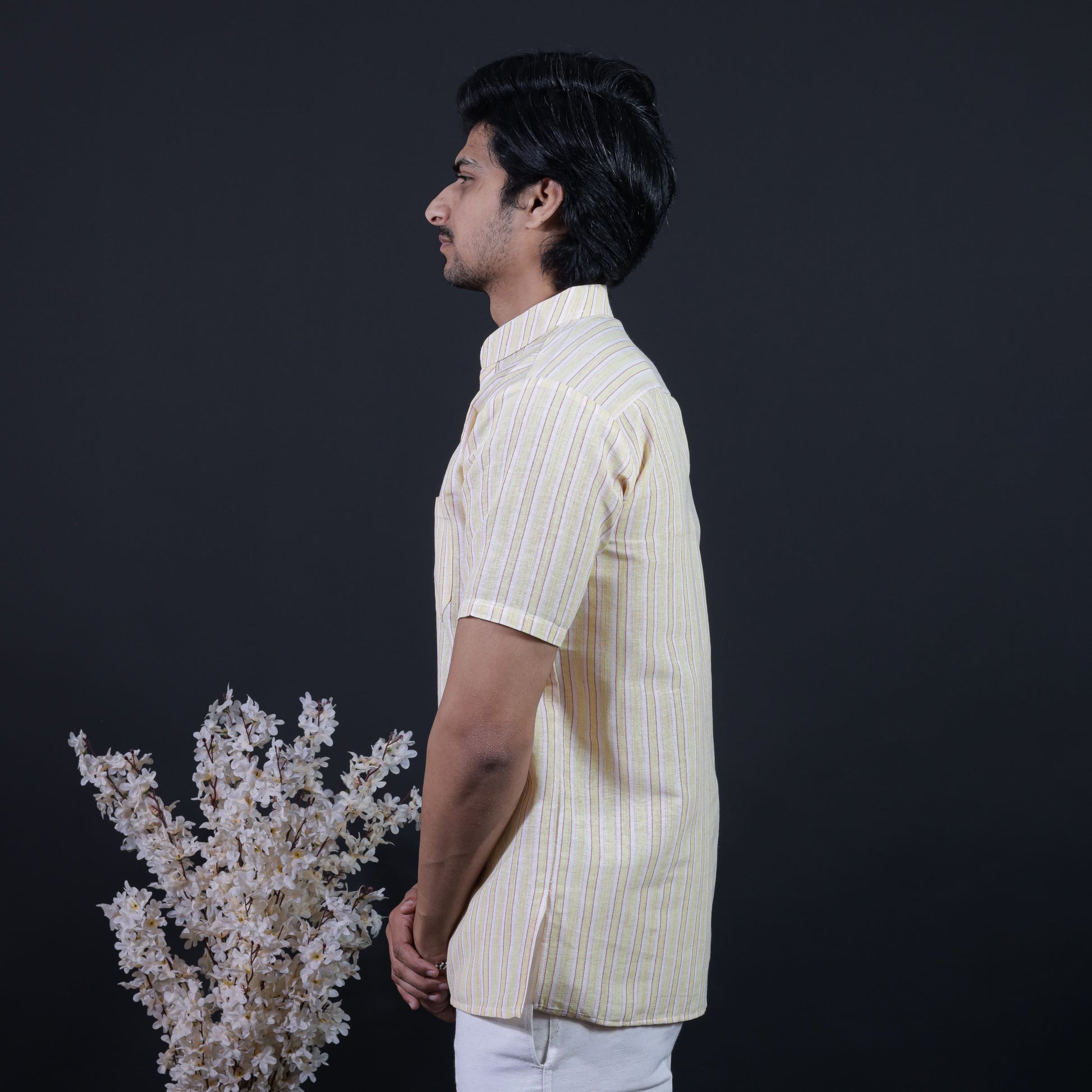 Side profile of yellow-toned white striped khadi short kurta for men
